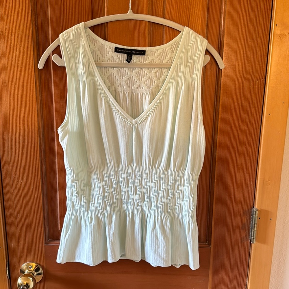 White House Black Market peplum tank in a light robin’s egg blue, size S